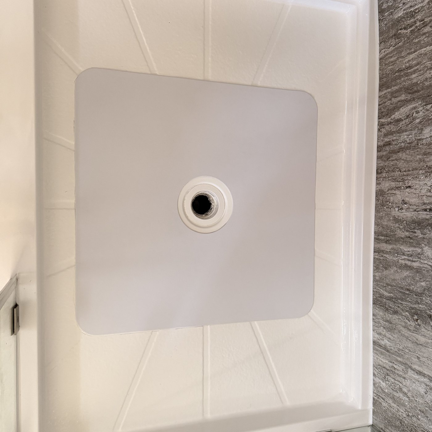 After — the shower pan floor rebuilt and covered with a bonded inlay, finished flush and clean.