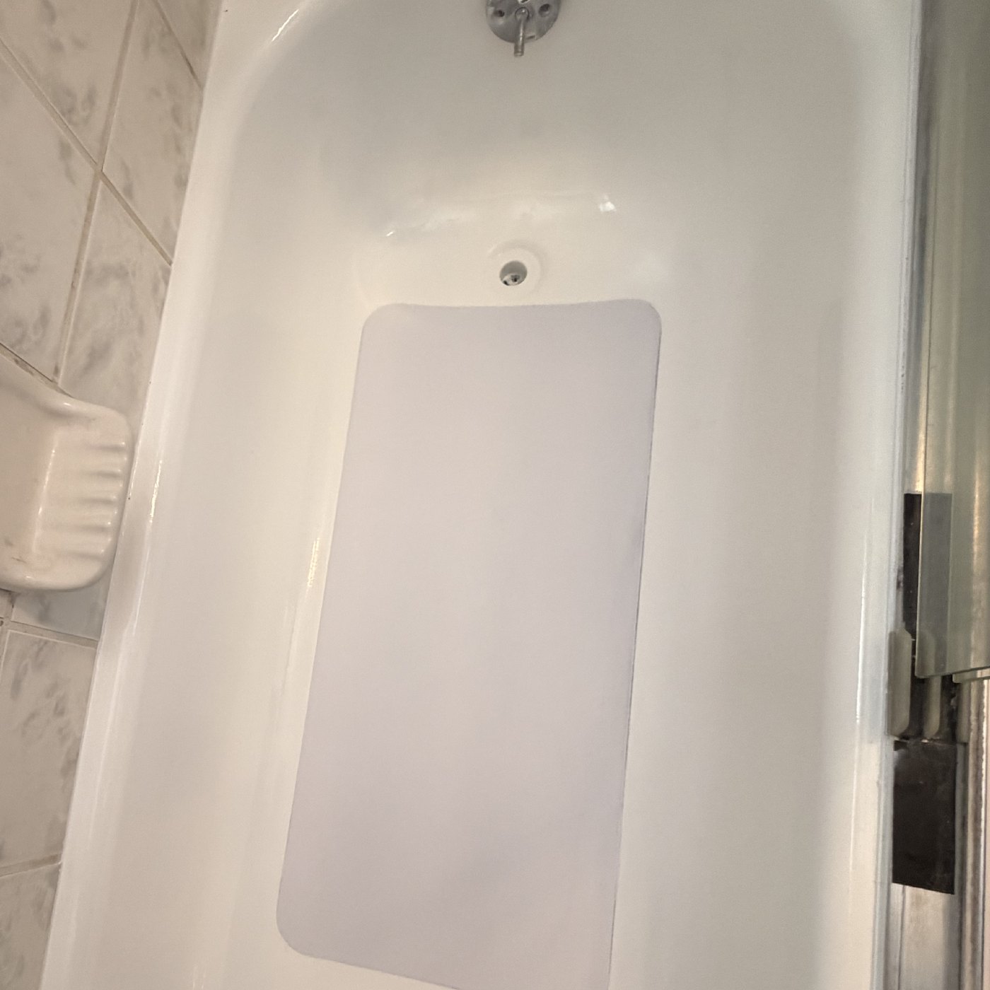 After — the same tub with a new inlay floor bonded over the repair, edges sealed flush and anti-slip texture built in.