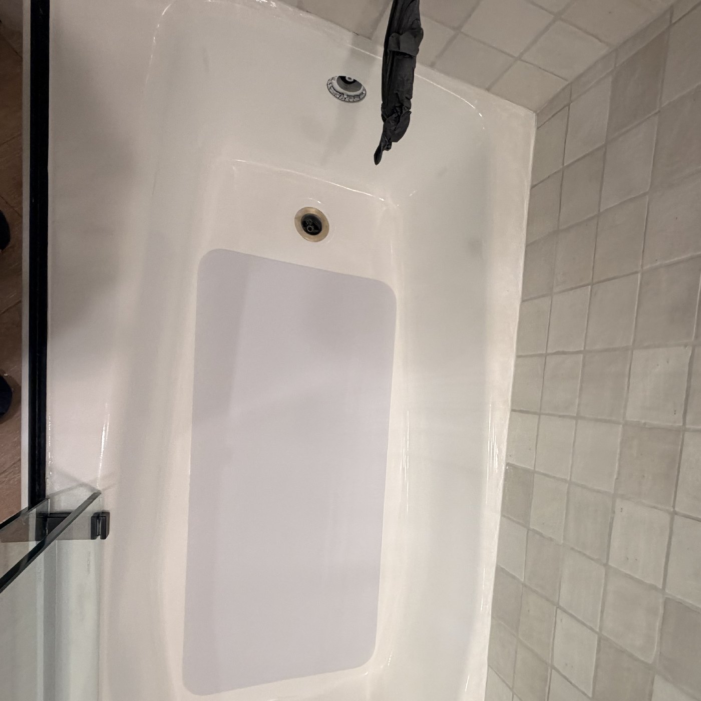 After — the same tub with a custom-cut inlay bonded over the damaged floor, finished flush and clean.